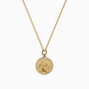 The Zodiac 14K Yellow Gold and Diamond Virgo Necklace features a round pendant with an engraved figure holding a star, accented by sparkling diamonds, shown on a plain white background.