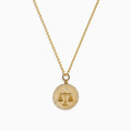 The Zodiac 14K Yellow Gold and Diamond Libra Necklace features a round pendant engraved with the scales of justice, surrounded by sparkling stones for a stunning astrological statement.