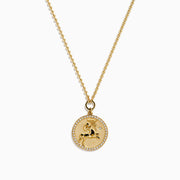 The Zodiac 14K Yellow Gold and Diamond Sagittarius Necklace features a round unicorn pendant with diamond accents on the edge, hanging from a simple gold chain—perfect as a unique zodiac necklace for everyday wear.