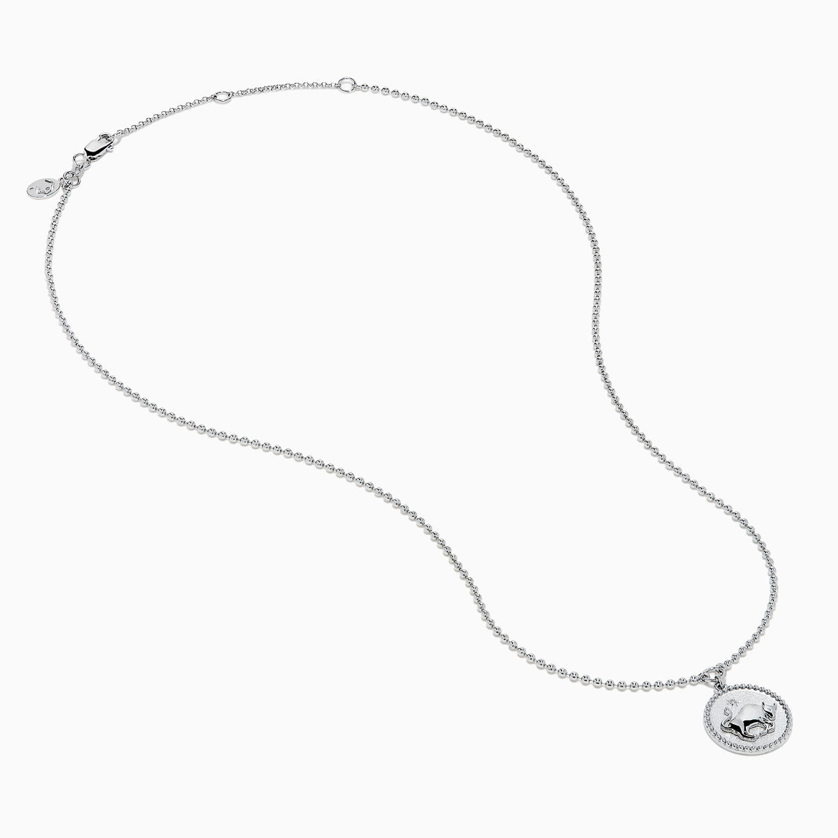 The Zodiac 925 Sterling Silver and Diamond Taurus Necklace features a round pendant with a raised bull design in the center, symbolizing Taurus, and is accented by a beaded edge.