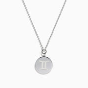 The Zodiac 925 Sterling Silver and Diamond Gemini Necklace features a round pendant engraved with two back-to-back human figures, shown against a plain white background.