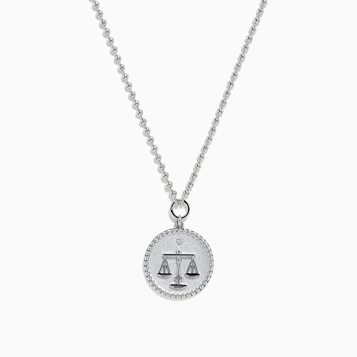 The Zodiac 925 Sterling Silver and Diamond Libra Necklace showcases a round pendant with engraved scales of justice, symbolizing Libra, suspended from a beaded chain.