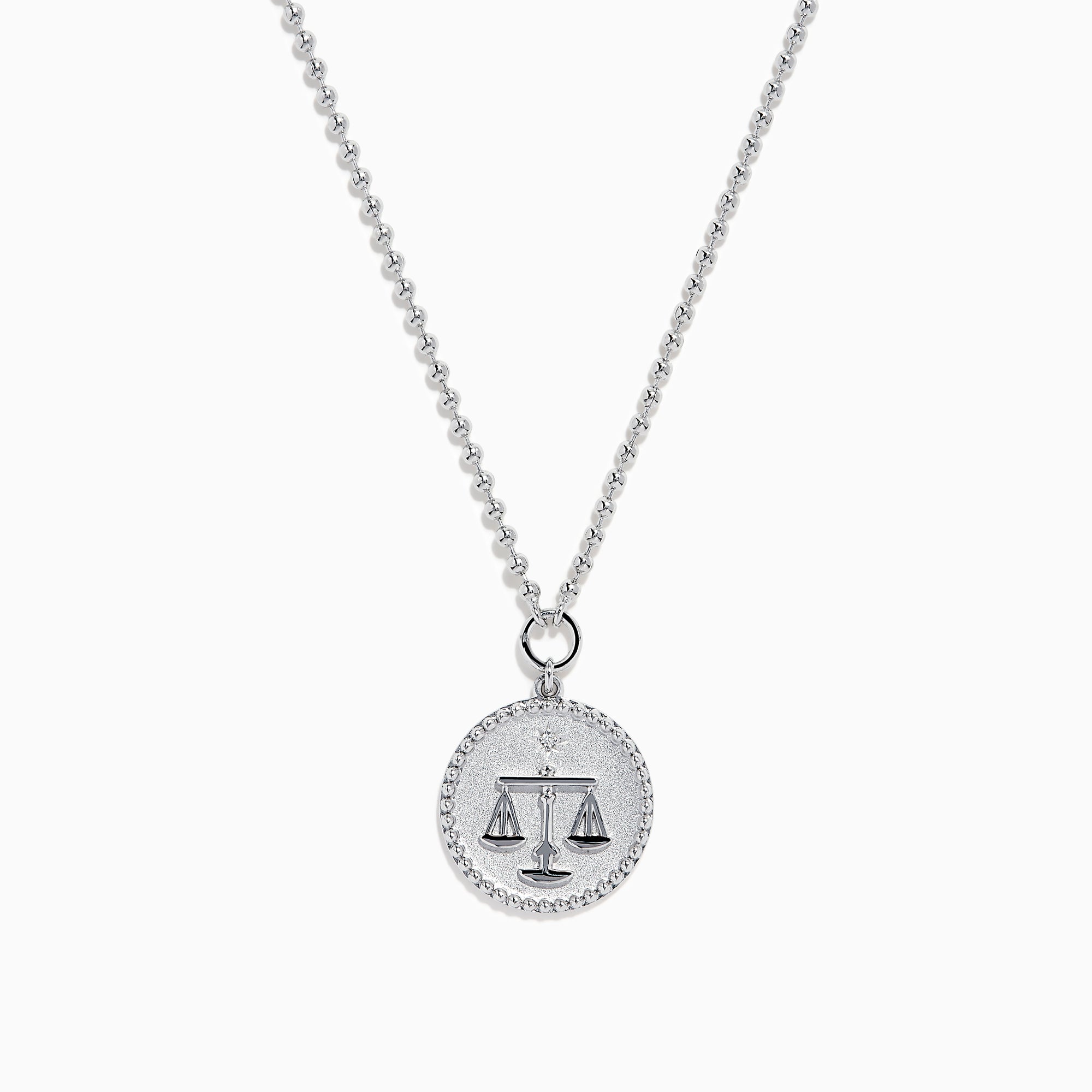 The Zodiac 925 Sterling Silver and Diamond Libra Necklace showcases a round pendant with engraved scales of justice, symbolizing Libra, suspended from a beaded chain.