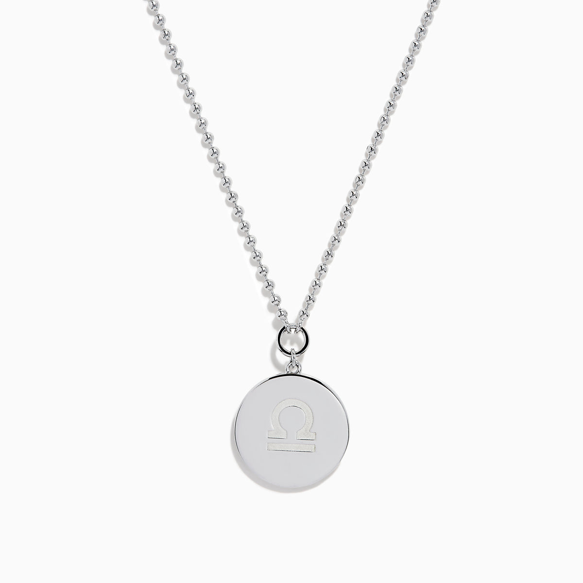 The Zodiac 925 Sterling Silver and Diamond Libra Necklace showcases a round pendant with engraved scales of justice, symbolizing Libra, suspended from a beaded chain.