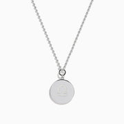 The Zodiac 925 Sterling Silver and Diamond Libra Necklace showcases a round pendant with engraved scales of justice, symbolizing Libra, suspended from a beaded chain.