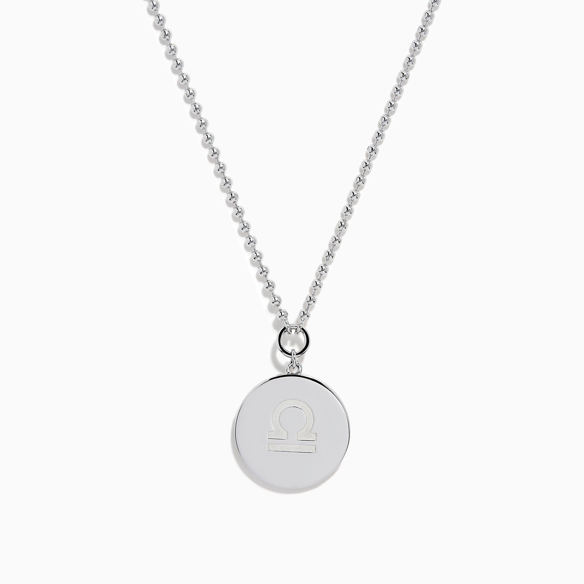 The Zodiac 925 Sterling Silver and Diamond Libra Necklace showcases a round pendant with engraved scales of justice, symbolizing Libra, suspended from a beaded chain.