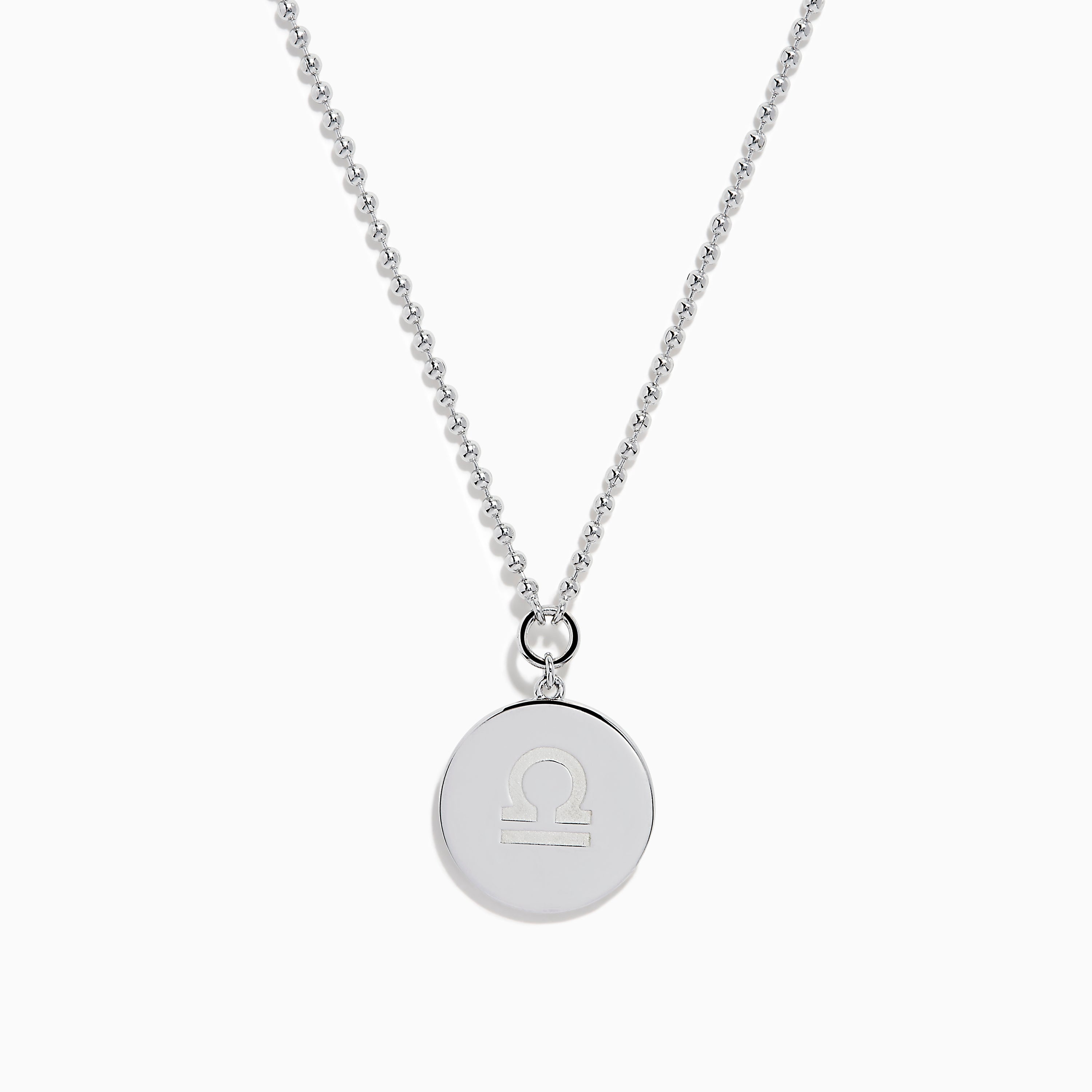 The Zodiac 925 Sterling Silver and Diamond Libra Necklace showcases a round pendant with engraved scales of justice, symbolizing Libra, suspended from a beaded chain.