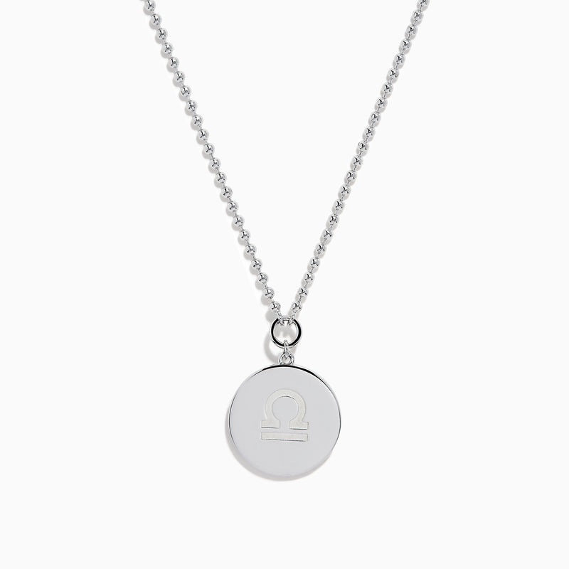 The Zodiac 925 Sterling Silver and Diamond Libra Necklace showcases a round pendant with engraved scales of justice, symbolizing Libra, suspended from a beaded chain.