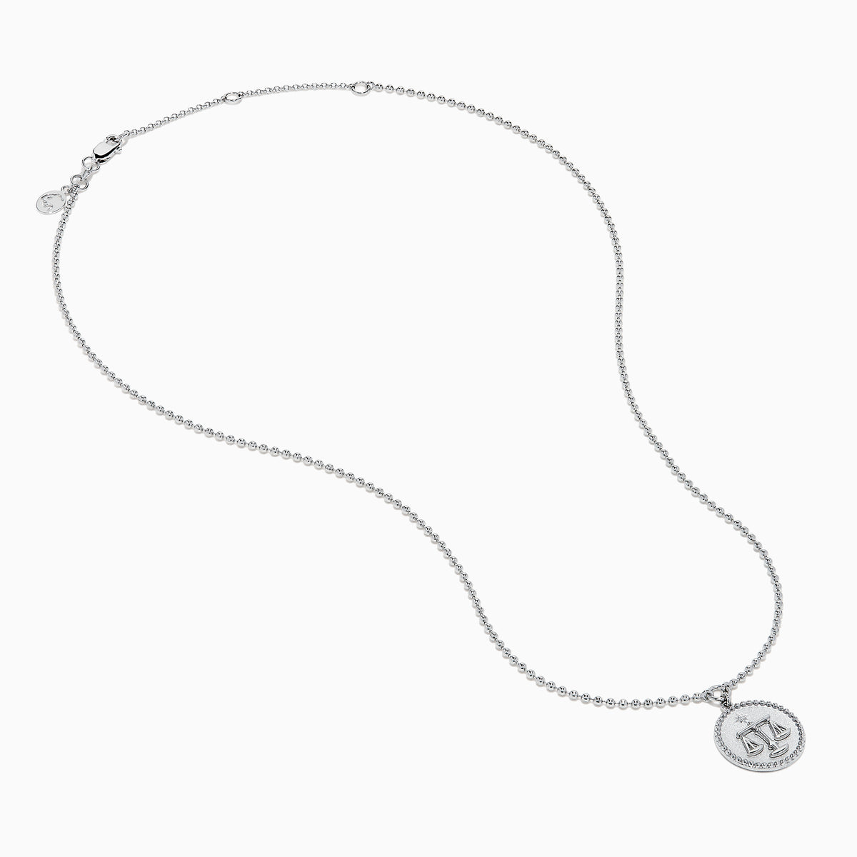 The Zodiac 925 Sterling Silver and Diamond Libra Necklace showcases a round pendant with engraved scales of justice, symbolizing Libra, suspended from a beaded chain.