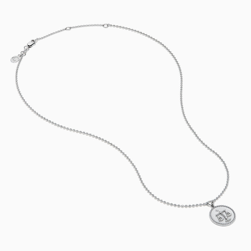 The Zodiac 925 Sterling Silver and Diamond Libra Necklace showcases a round pendant with engraved scales of justice, symbolizing Libra, suspended from a beaded chain.