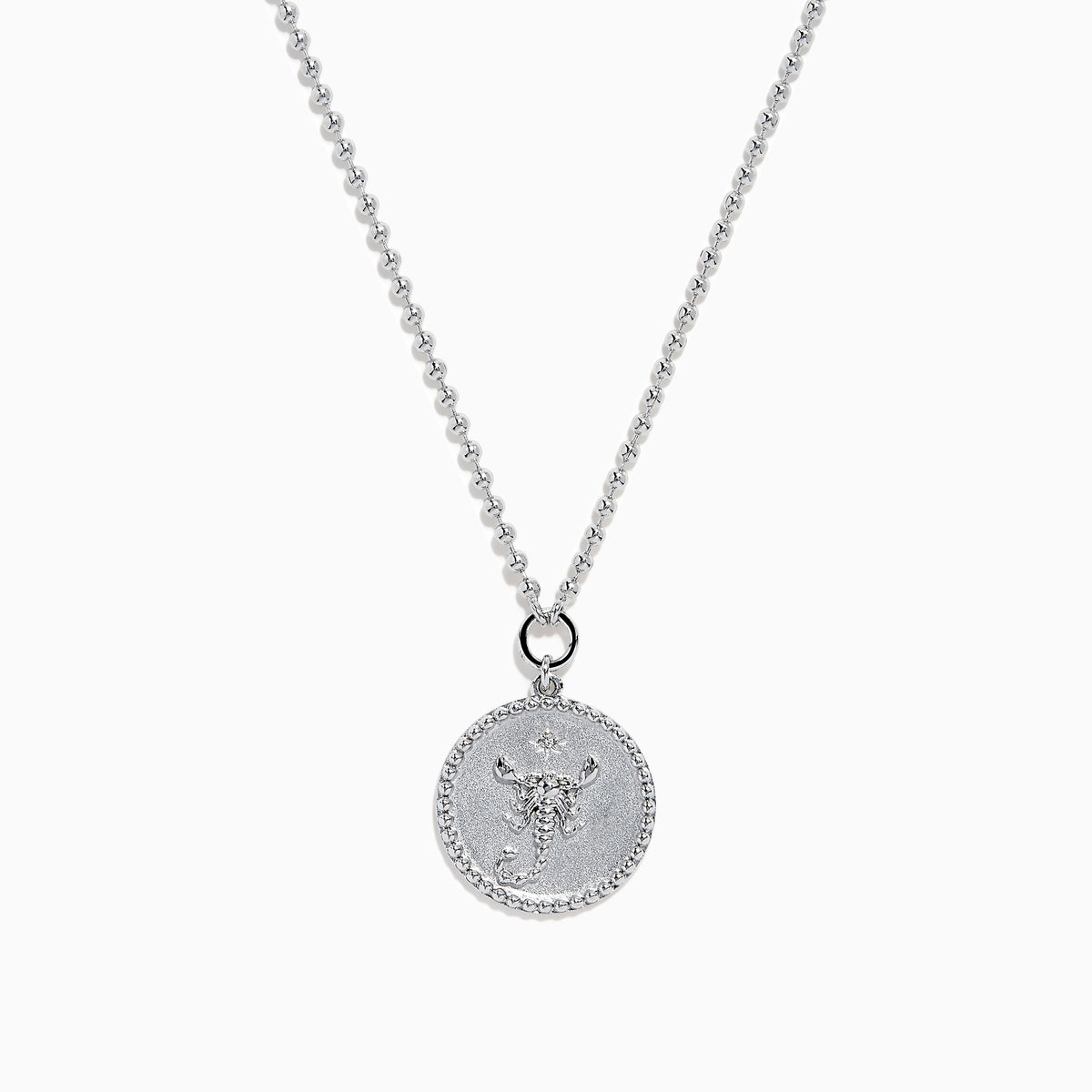 The Zodiac 925 Sterling Silver and Diamond Scorpio Necklace features a round, textured pendant with an engraved scorpion design, hanging from a beaded chain against a white background.