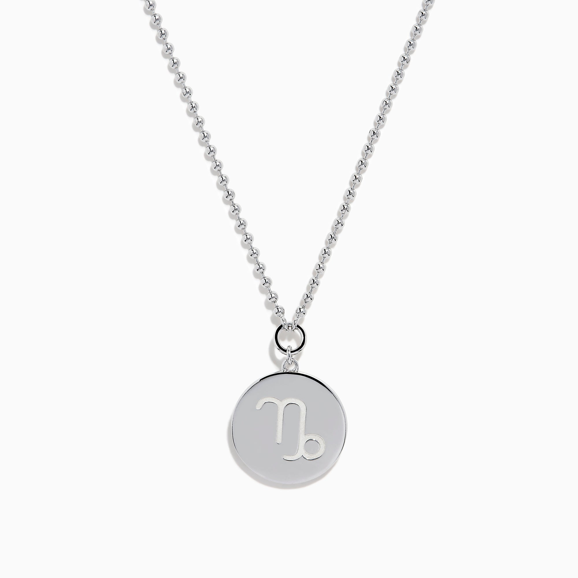 The Zodiac 925 Sterling Silver and Diamond Capricorn Necklace features a round, textured pendant engraved with a figure playing soccer, offering a unique twist on the classic Zodiac style. Shown against a plain white background.