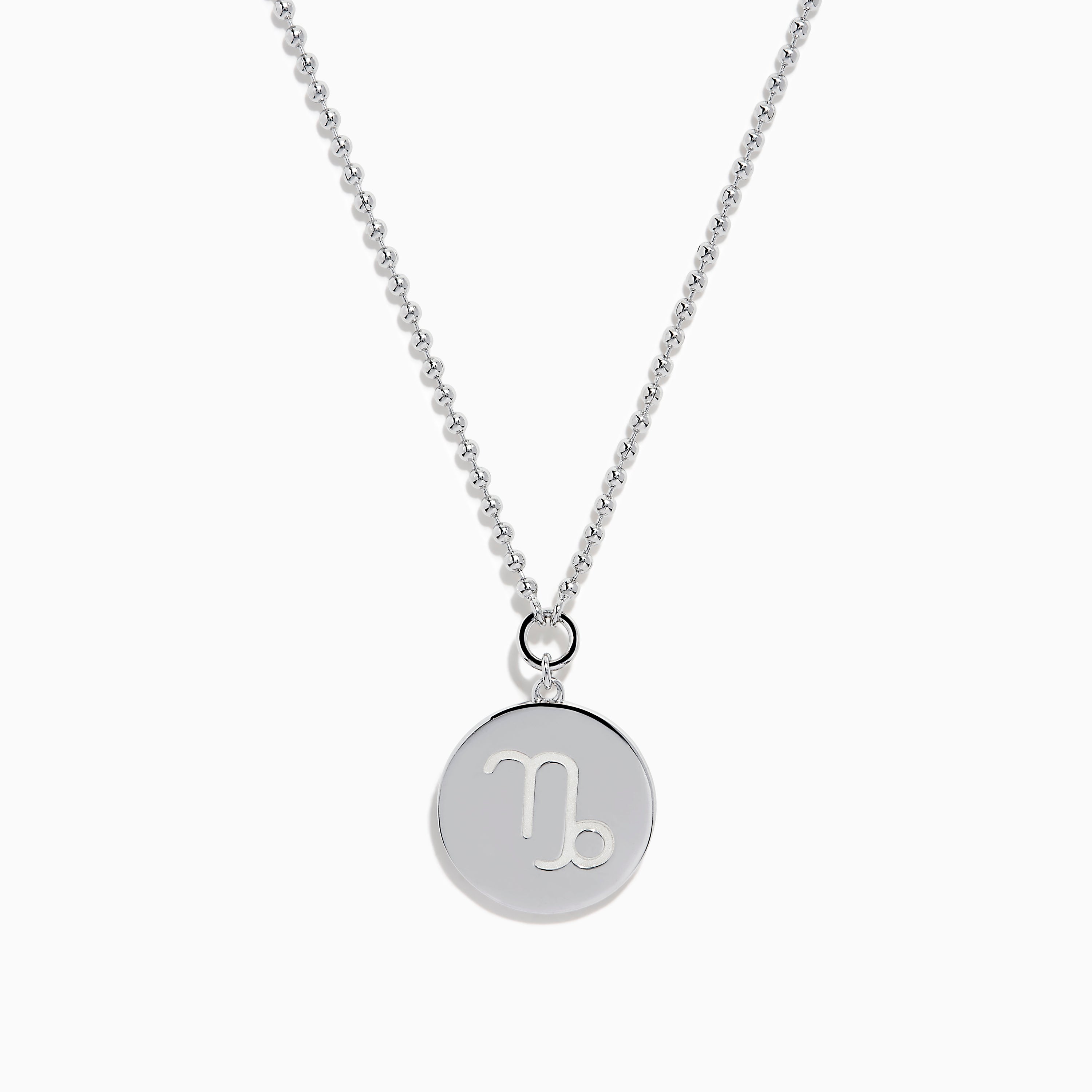 The Zodiac 925 Sterling Silver and Diamond Capricorn Necklace features a round, textured pendant engraved with a figure playing soccer, offering a unique twist on the classic Zodiac style. Shown against a plain white background.