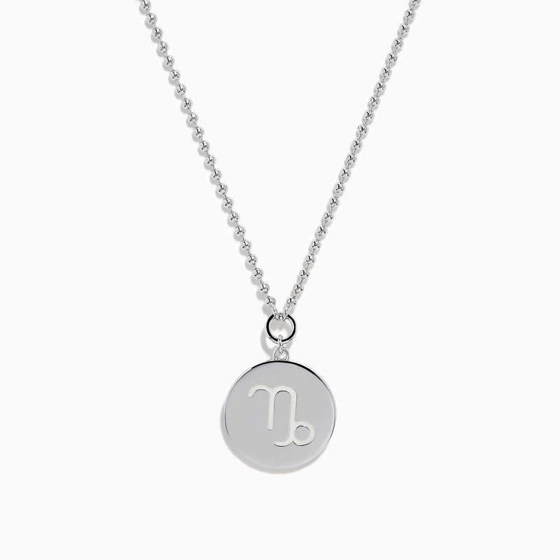The Zodiac 925 Sterling Silver and Diamond Capricorn Necklace features a round, textured pendant engraved with a figure playing soccer, offering a unique twist on the classic Zodiac style. Shown against a plain white background.