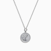 The Zodiac 925 Sterling Silver and Diamond Aquarius Necklace features a round, textured pendant engraved with a kneeling figure in prayer, offering a subtle yet meaningful tribute to the Aquarius sign.