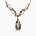 The 14K Rose Gold Espresso and White Diamond Drop Necklace features an intricate design with black and gold sections, encrusted with espresso diamonds, and a striking teardrop-shaped pendant at the center.