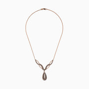 The 14K Rose Gold Espresso and White Diamond Drop Necklace features an intricate design with black and gold sections, encrusted with espresso diamonds, and a striking teardrop-shaped pendant at the center.