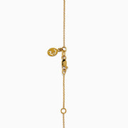 The DOro 14K Yellow Gold Diamond Necklace features a delicate gold chain and a round pendant with a cluster of sparkling diamonds at the center.