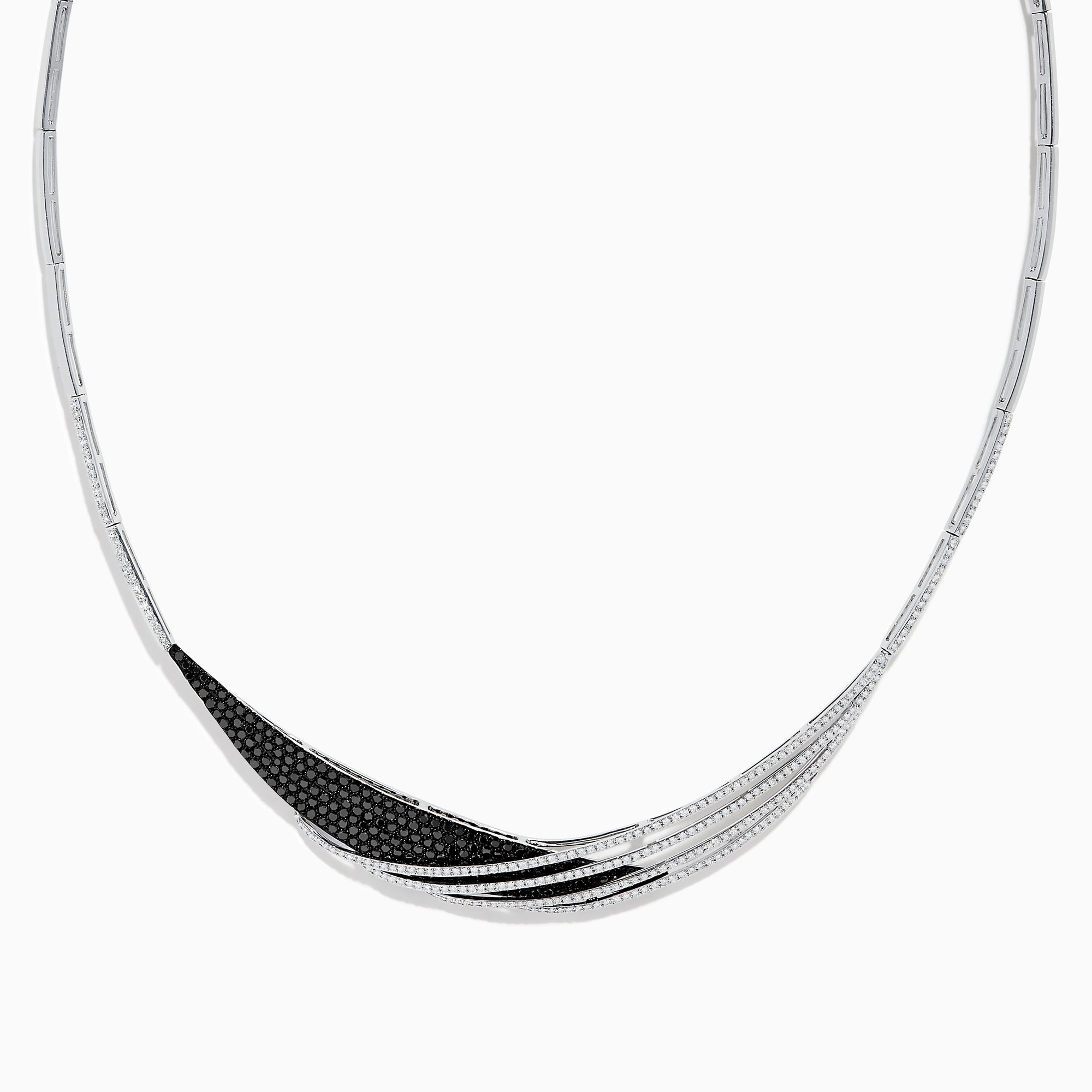 The 14K White Gold Black and White Diamond Necklace features an asymmetrical, sweeping design with textured sections set with small black diamonds.