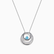The Lab Grown Blue and White Diamond Circle Pendant in 14K White Gold features a circular pendant with clear and blue stones, displayed on a plain white background.
