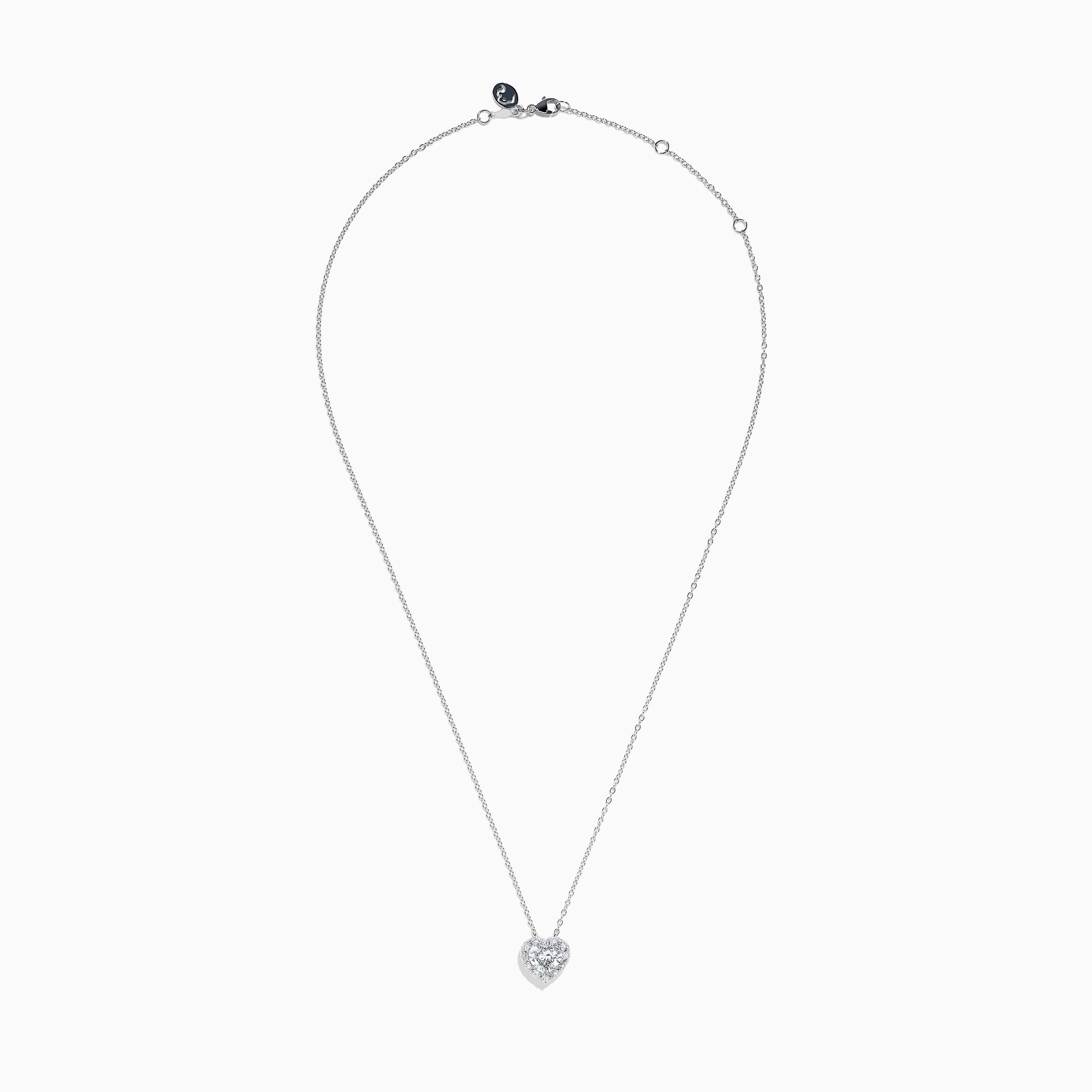 The Lab Grown Heart and Round Diamond Halo Pendant in 14K White Gold features a sparkling heart-shaped lab grown diamond with a halo of smaller diamonds on a delicate silver chain, shown against a plain white background.