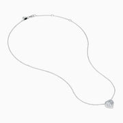 The Lab Grown Heart and Round Diamond Halo Pendant in 14K White Gold features a sparkling heart-shaped lab grown diamond with a halo of smaller diamonds on a delicate silver chain, shown against a plain white background.