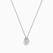The Lab Grown Pear Diamond Bezel Pendant in 14K White Gold features a delicate silver chain and a pear-shaped lab grown diamond in an elegant bezel setting, showcased against a white background.