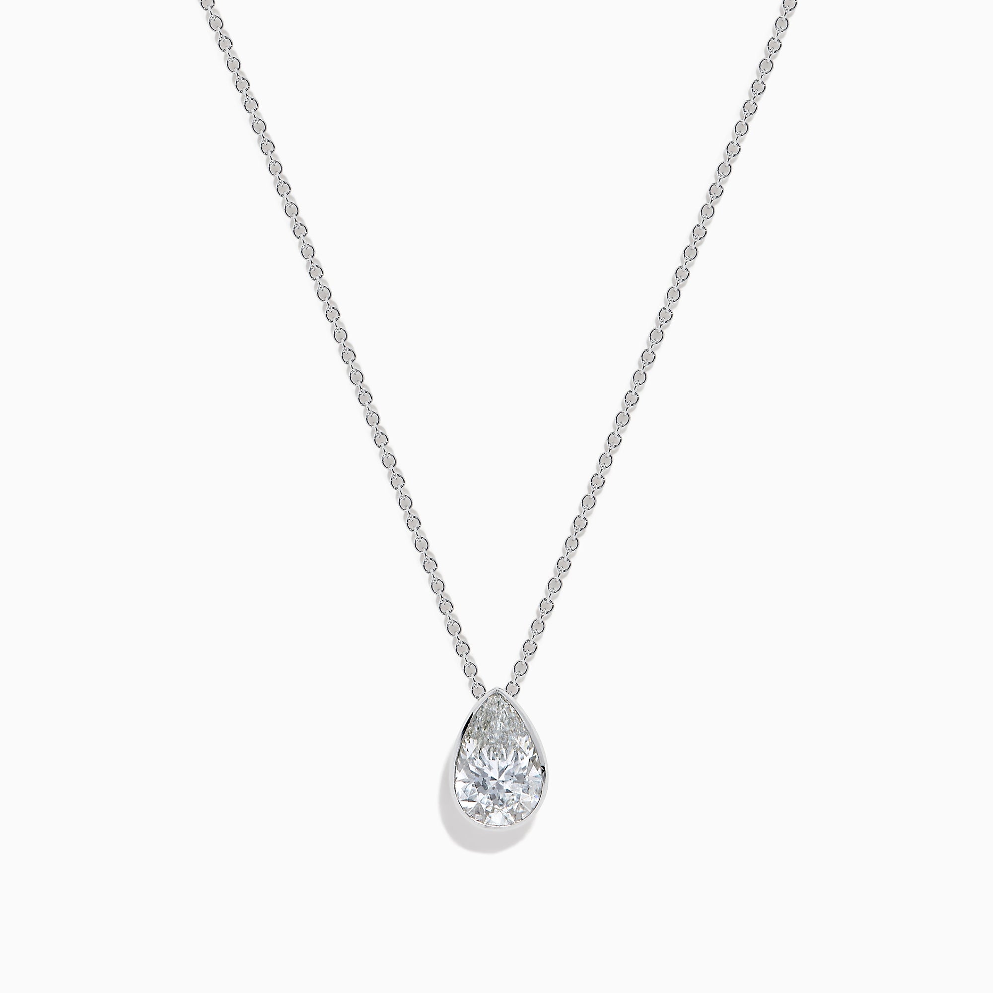 The Lab Grown Pear Diamond Bezel Pendant in 14K White Gold features a delicate silver chain and a pear-shaped lab grown diamond in an elegant bezel setting, showcased against a white background.