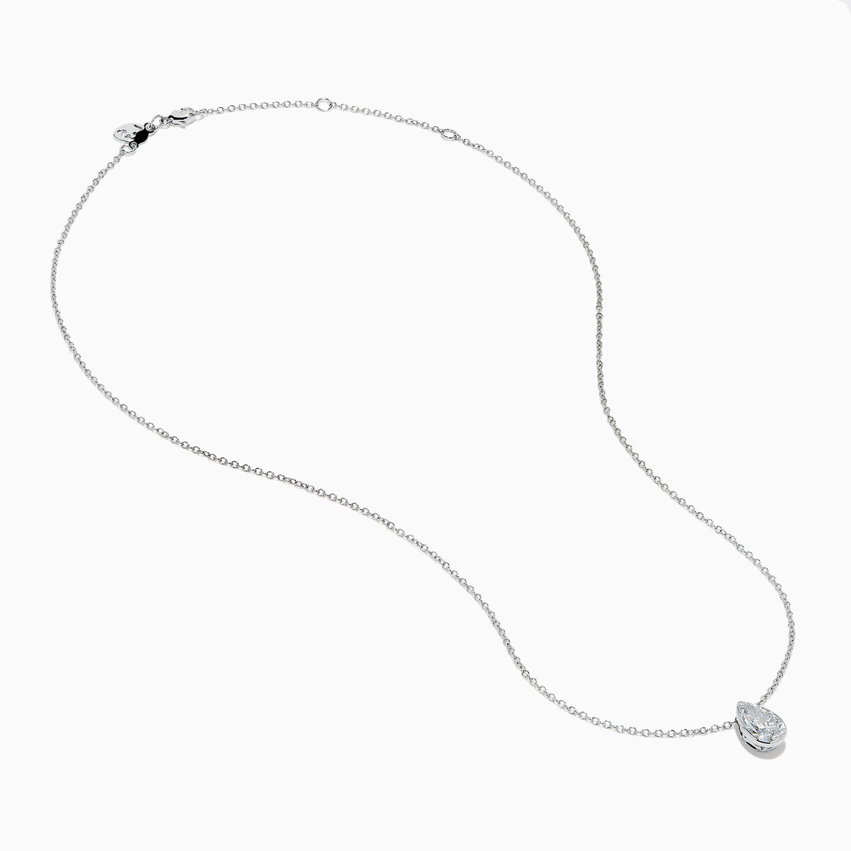 The Lab Grown Pear Diamond Bezel Pendant in 14K White Gold features a delicate silver chain and a pear-shaped lab grown diamond in an elegant bezel setting, showcased against a white background.