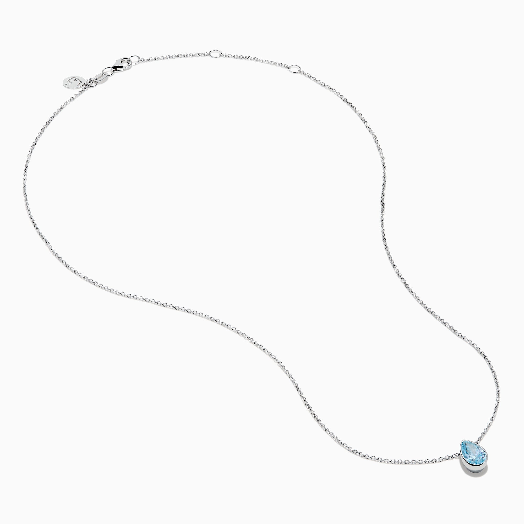 The Lab Grown Pear Solitaire Blue Diamond Collarbone Necklace in 14K White Gold features a minimalist bezel-set, teardrop-shaped blue diamond pendant on a fine white gold chain, elegantly displayed against a white background.