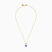 The Nahla 14K Yellow Gold Oval Tanzanite and Diamond Pendant features an oval tanzanite encircled by sparkling diamonds, displayed on a sleek yellow gold chain against a plain white background.