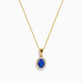 The Nahla 14K Yellow Gold Oval Tanzanite and Diamond Pendant features an oval tanzanite encircled by sparkling diamonds, displayed on a sleek yellow gold chain against a plain white background.