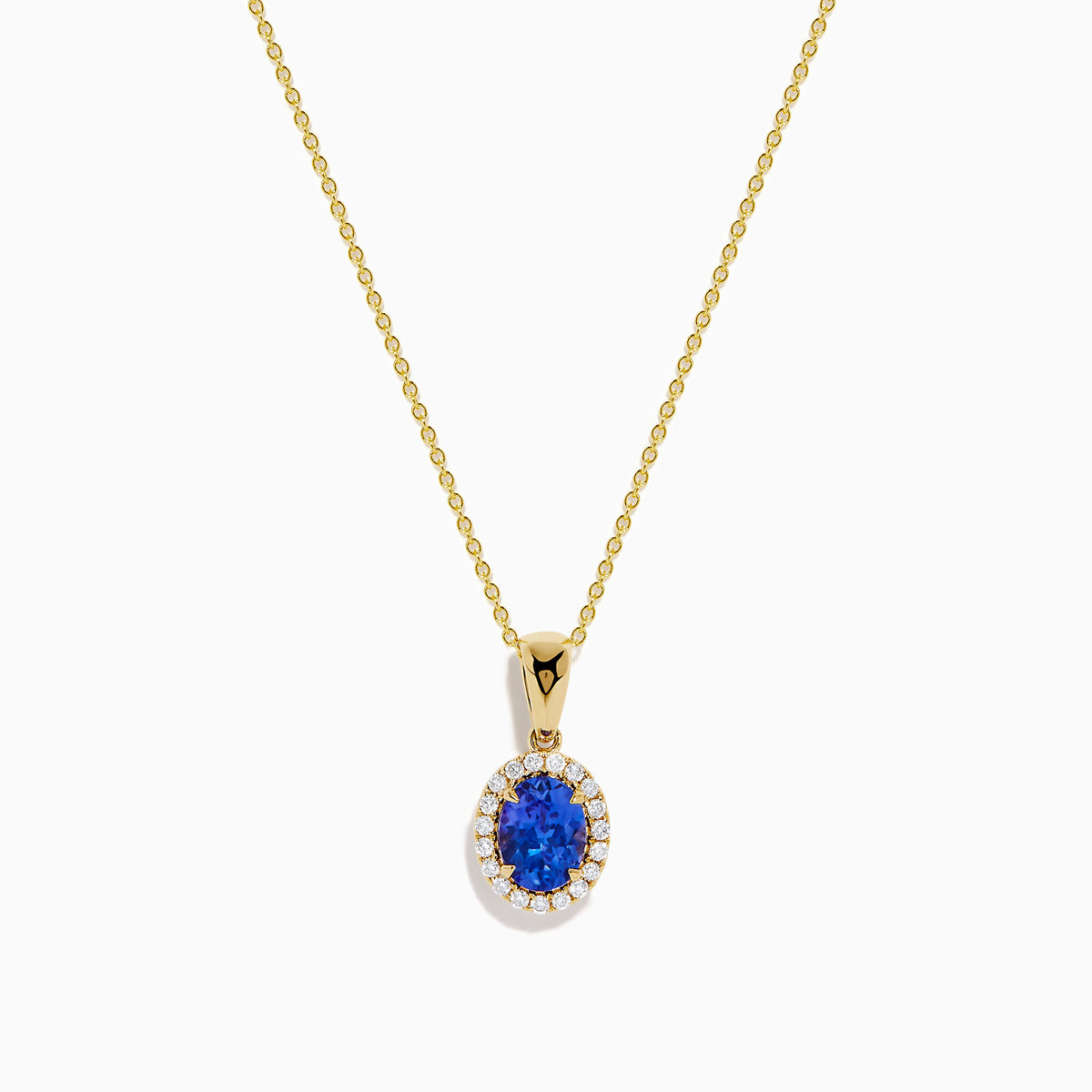 The Nahla 14K Yellow Gold Oval Tanzanite and Diamond Pendant features an oval tanzanite encircled by sparkling diamonds, displayed on a sleek yellow gold chain against a plain white background.