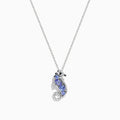 The Seaside 925 Sterling Silver Tanzanite and Diamond Seahorse Pendant features a sparkling seahorse design with tanzanite and diamond accents, hanging from a delicate chain on a white background.