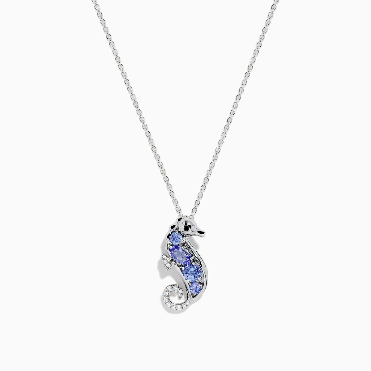 The Seaside 925 Sterling Silver Tanzanite and Diamond Seahorse Pendant features a sparkling seahorse design with tanzanite and diamond accents, hanging from a delicate chain on a white background.