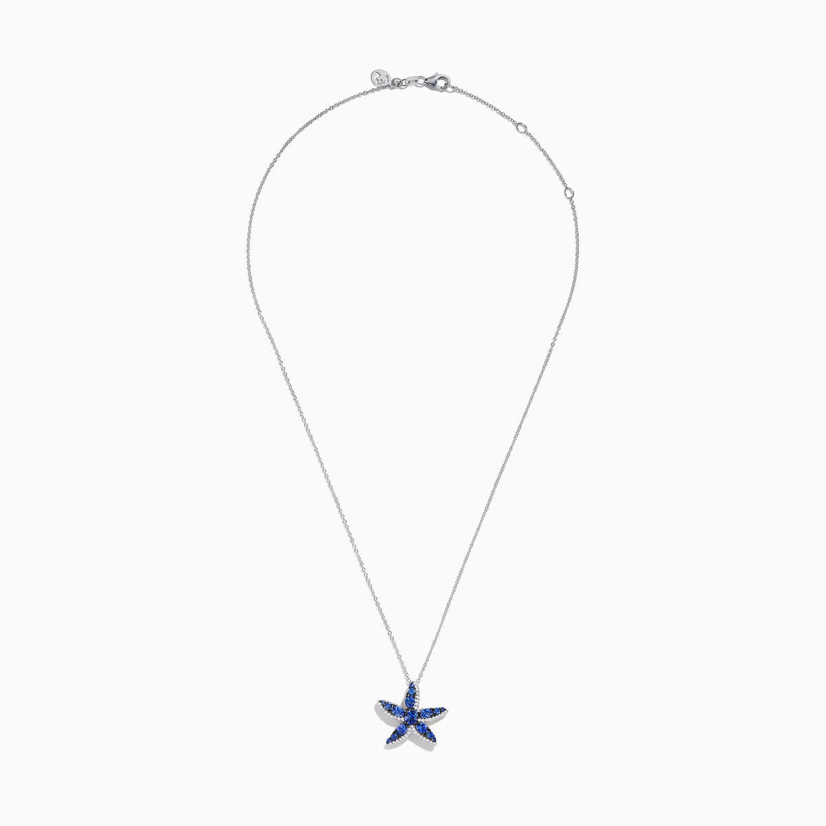 The 925 Silver Tanzanite and Diamond Starfish Pendant features a sparkling starfish design, adorned with tanzanite and diamonds, displayed against a white background.