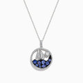 The 925 Sterling Silver Tanzanite and Diamond Sailboat Pendant features a round design with a sailboat, sparkling tanzanite wave accents, and a diamond representing the sun or moon above the boat.