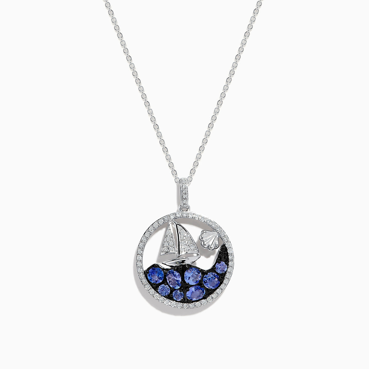 The 925 Sterling Silver Tanzanite and Diamond Sailboat Pendant features a round design with a sailboat, sparkling tanzanite wave accents, and a diamond representing the sun or moon above the boat.