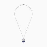 The 925 Sterling Silver Tanzanite and Diamond Sailboat Pendant features a round design with a sailboat, sparkling tanzanite wave accents, and a diamond representing the sun or moon above the boat.