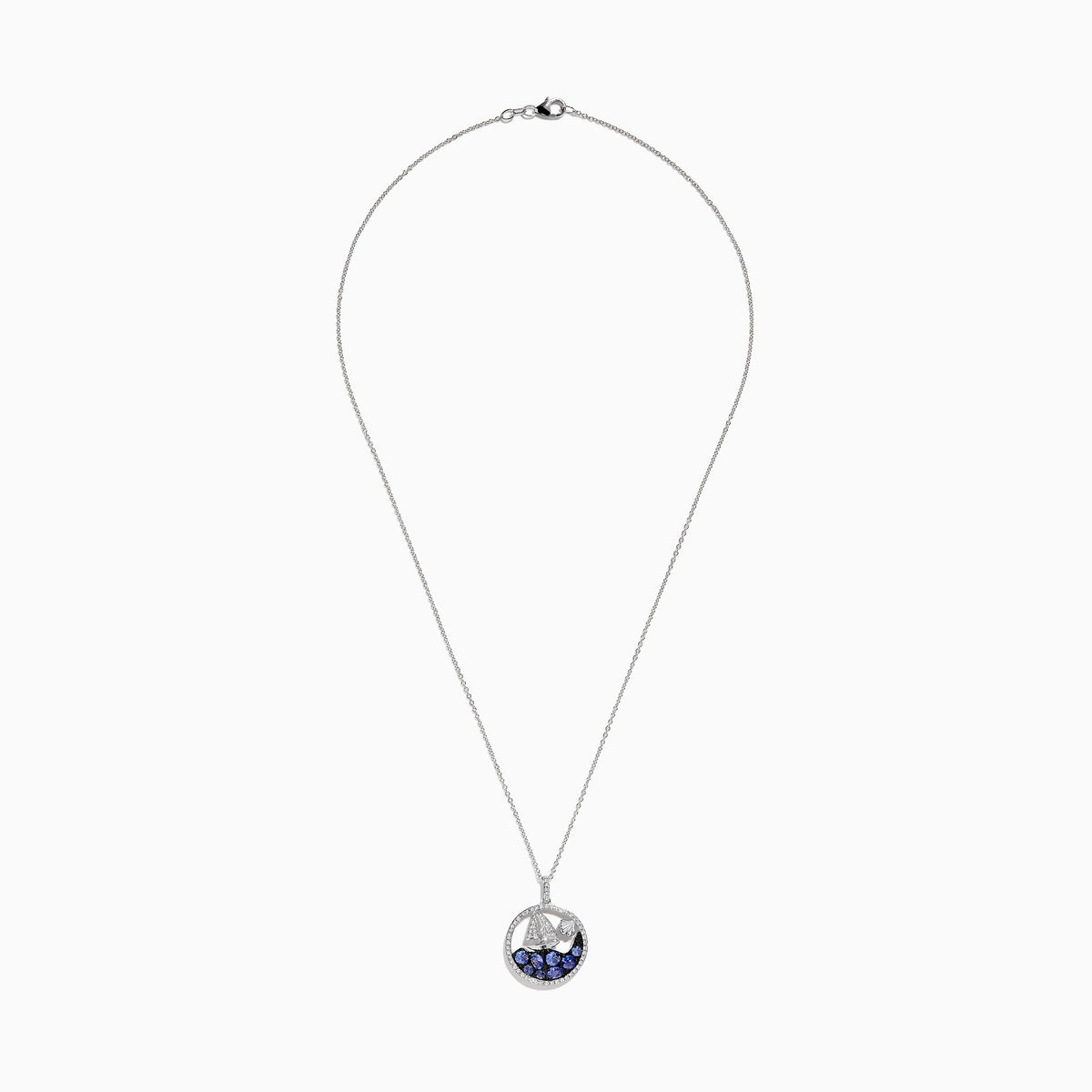 The 925 Sterling Silver Tanzanite and Diamond Sailboat Pendant features a round design with a sailboat, sparkling tanzanite wave accents, and a diamond representing the sun or moon above the boat.