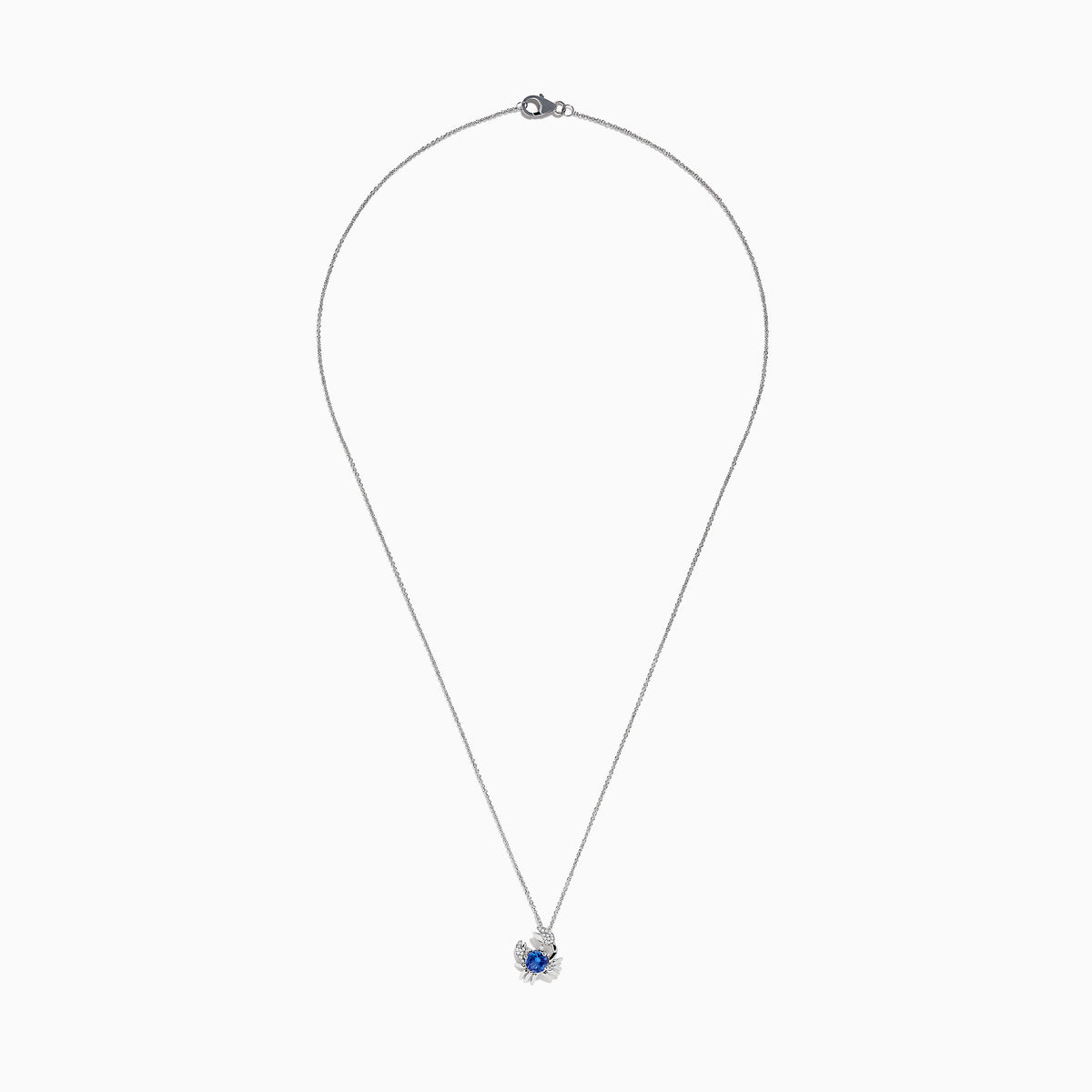 The 925 Silver Tanzanite and Diamond Crab Pendant features a round blue tanzanite gemstone at the center and small clear stones accenting the crab’s claws.