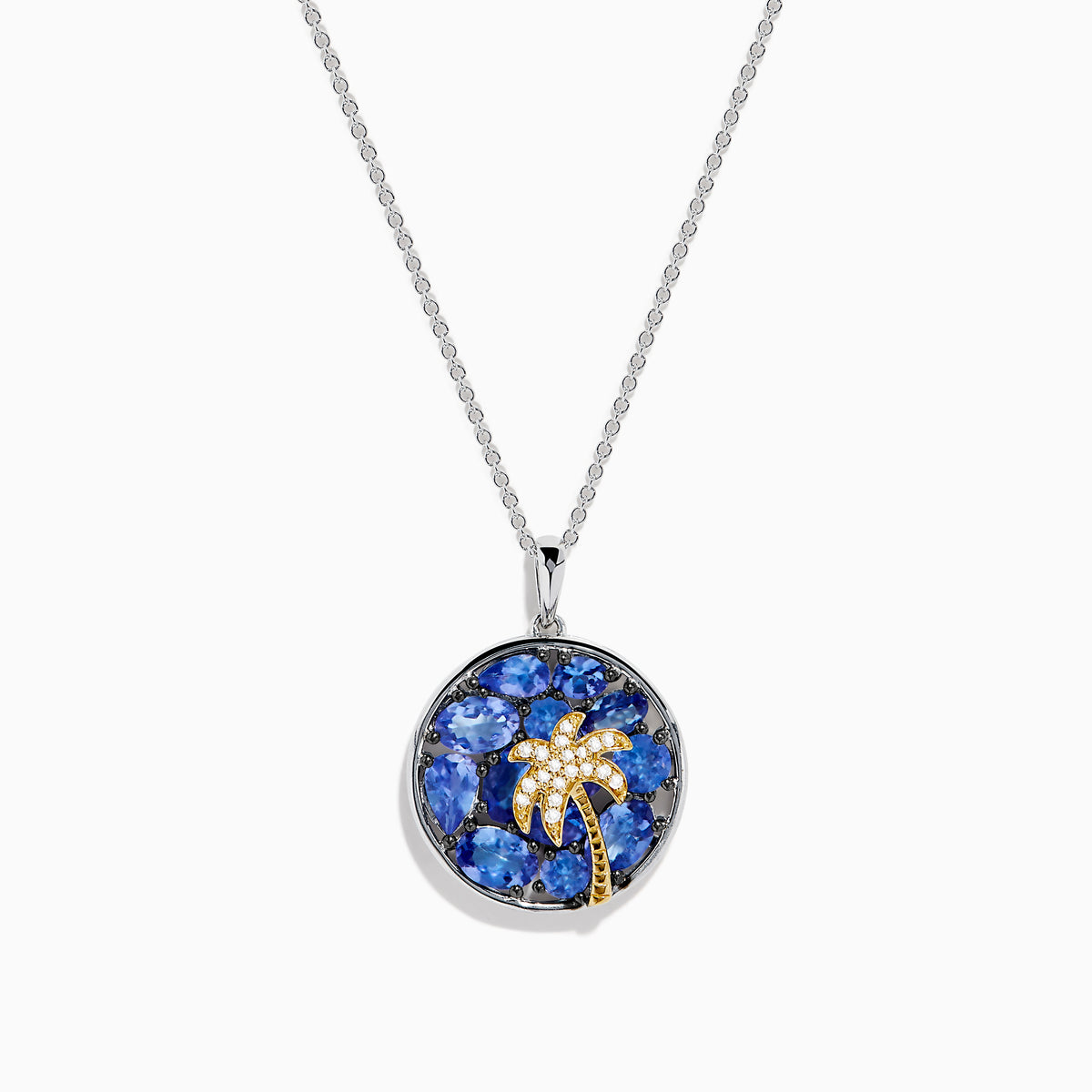 The Nahla 925 Sterling Silver and 14K Yellow Gold Tanzanite & Diamond Palm Tree Pendant features tanzanite gemstones, sparkling diamonds, and a gold palm tree design on a round pendant.