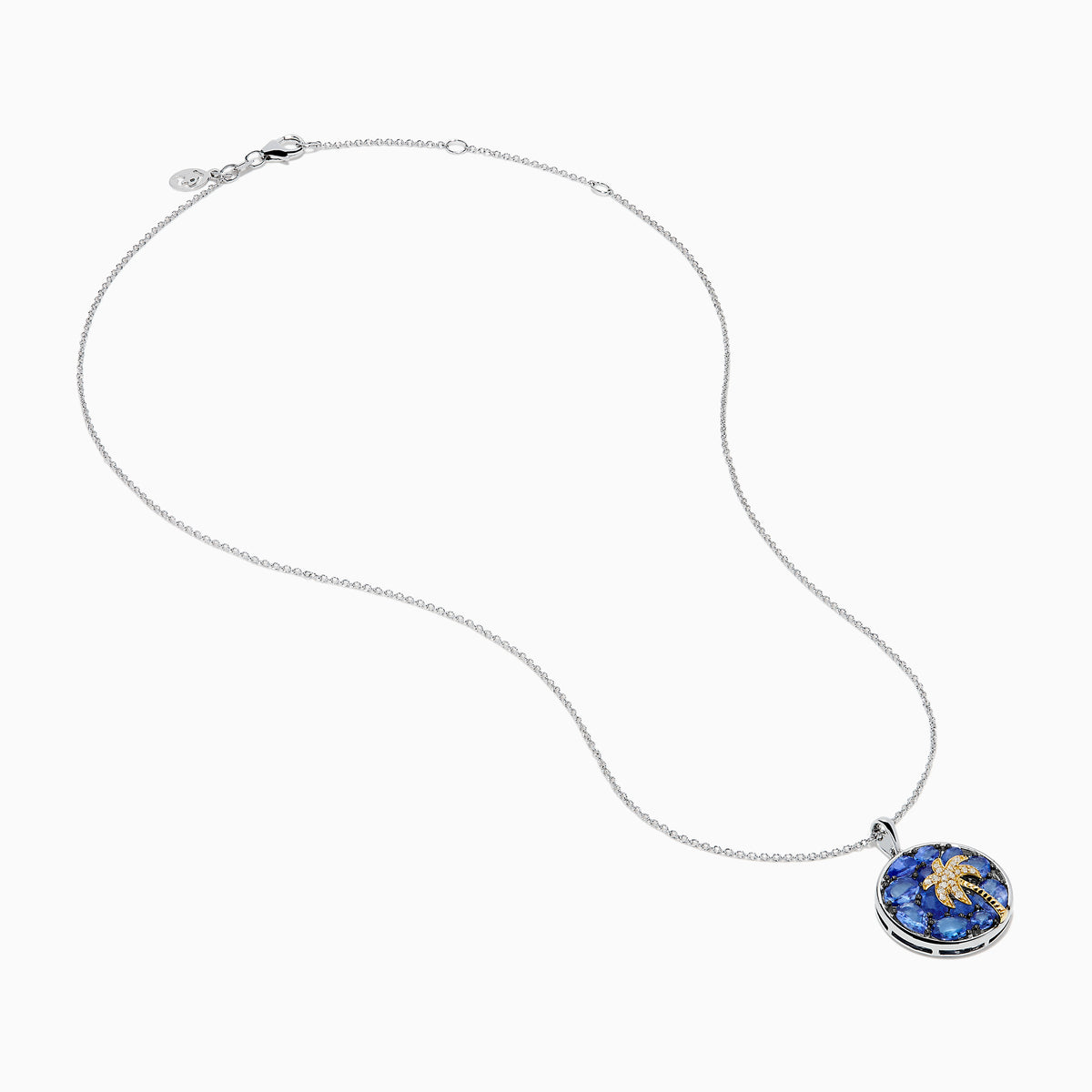 The Nahla 925 Sterling Silver and 14K Yellow Gold Tanzanite & Diamond Palm Tree Pendant features tanzanite gemstones, sparkling diamonds, and a gold palm tree design on a round pendant.