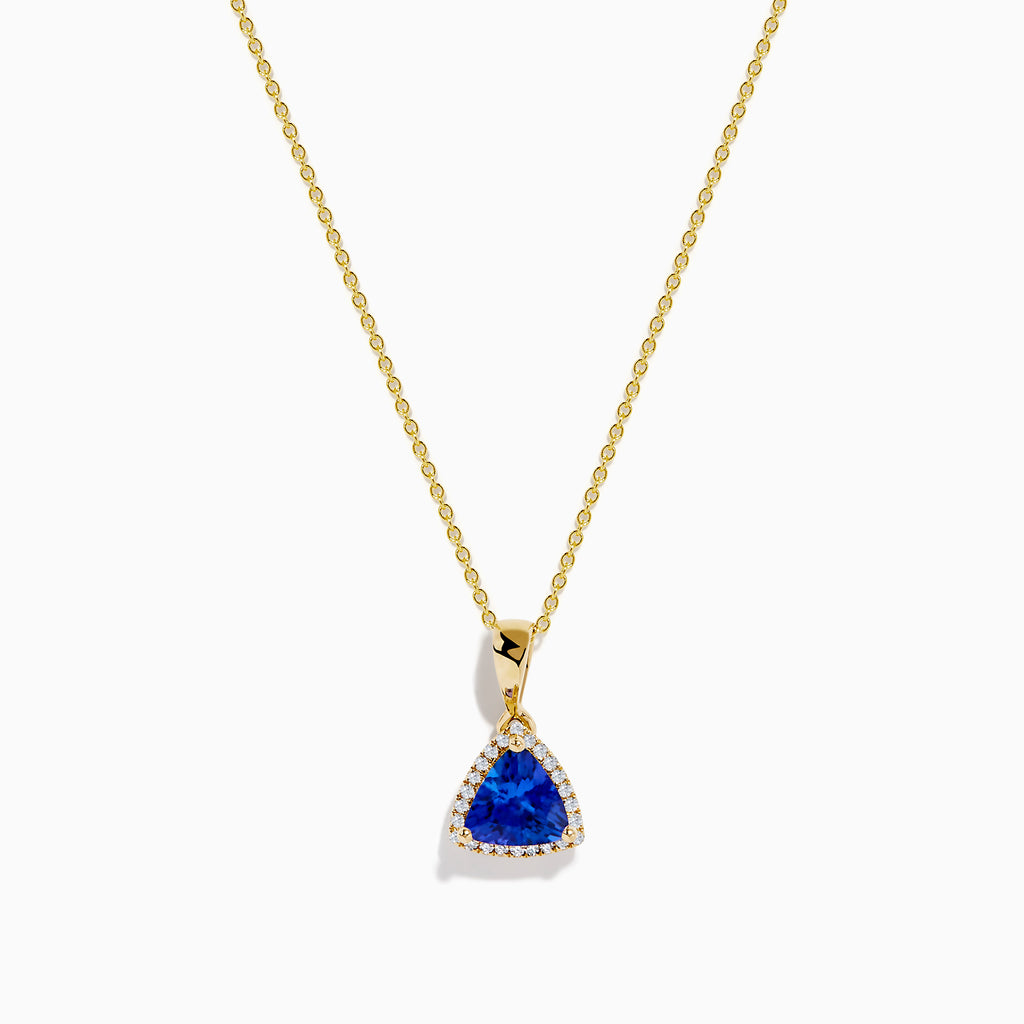 The Nahla Siri 14K Yellow Gold Tanzanite and Diamond Pendant features a triangular tanzanite accented by sparkling diamonds, set on a delicate gold chain against a white background.