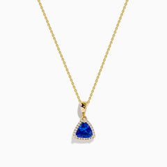 The Nahla Siri 14K Yellow Gold Tanzanite and Diamond Pendant features a triangular tanzanite accented by sparkling diamonds, set on a delicate gold chain against a white background.