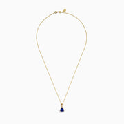 The Nahla Siri 14K Yellow Gold Tanzanite and Diamond Pendant features a triangular tanzanite accented by sparkling diamonds, set on a delicate gold chain against a white background.
