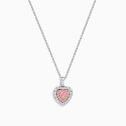 The 18K Two Tone Gold Pink and White Diamond Heart Pendant features sparkling pink center stones bordered by clear diamonds, creating a dazzling accessory perfect for any occasion.