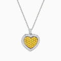 The 18K Two Tone Gold White and Yellow Diamond Heart Cluster Pendant features a heart shape bordered with white diamonds and a center of yellow diamonds, creating a vibrant, elegant design.