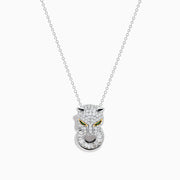 The Signature 14K White Gold Diamond and Emerald Panther Pendant features a panther head encrusted with diamond-like gems, yellow gemstone eyes, and a ring in its mouth, hanging from a delicate white gold chain.