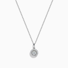 The Pave Classica 14K White Gold Diamond Halo Pendant (0.49 TCW) features a round center diamond with a sparkling halo, suspended from a delicate white gold chain. Displayed on a plain background, this piece reflects timeless elegance.
